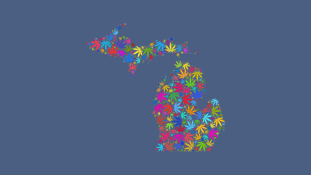 Michigan silhouette made from multicolored cannabis leaves on a muted blue background.