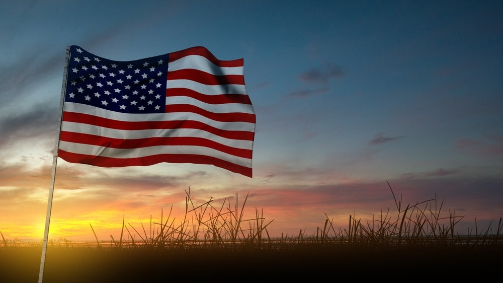 American flag waving at sunset for a guide to evaluating Made-in-USA cannabis packaging claims.