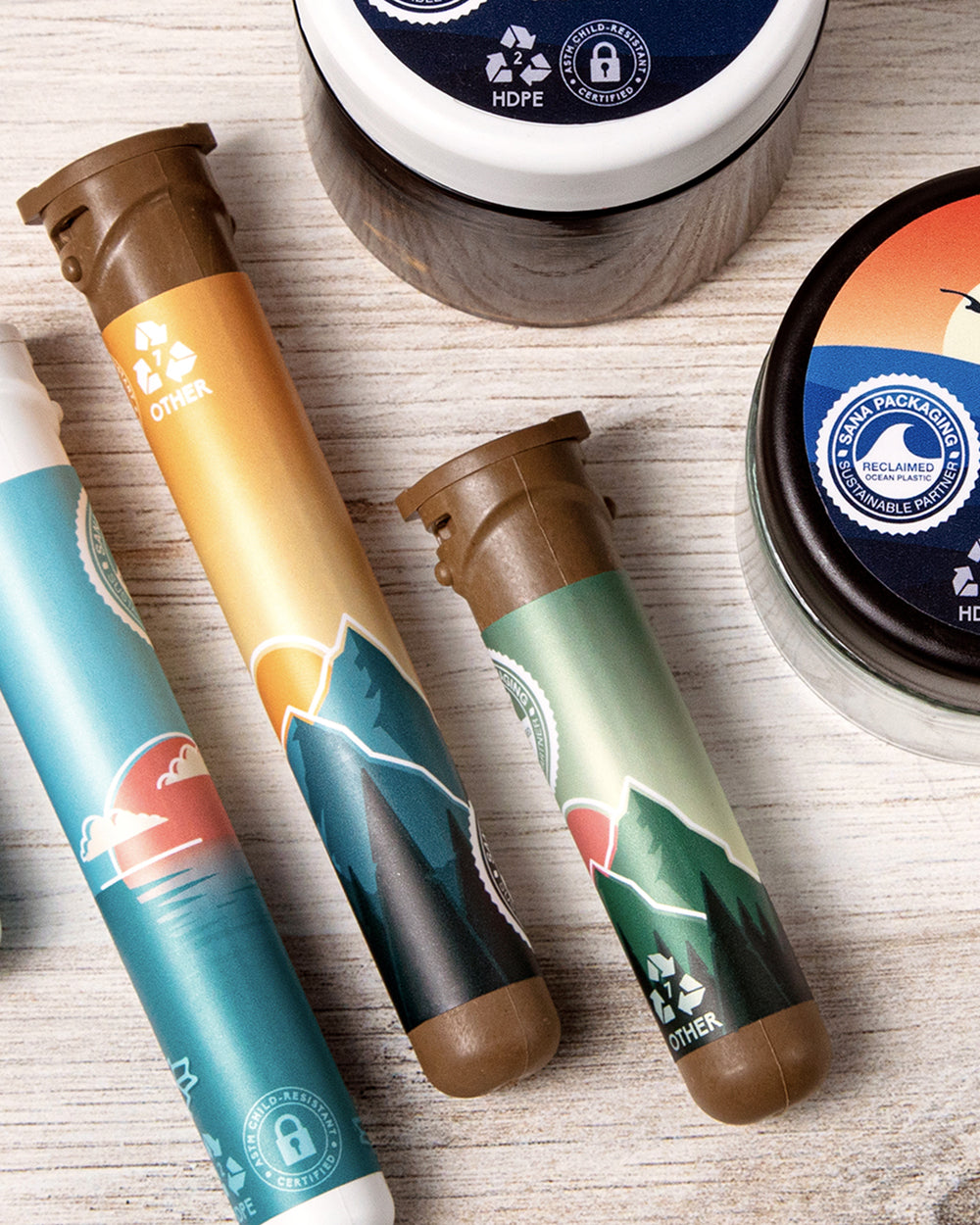 Custom-branded 78mm Hemp Tube alongside other Sana Packaging products on a wooden surface