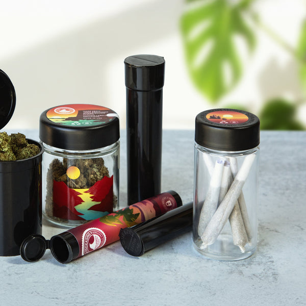 Sana Packaging glass jars, child-resistant container and pre-roll tubes on a stone surface